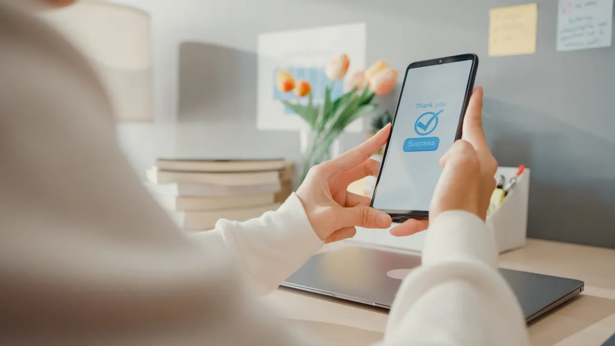 Person manually approving an AI agent's proposed action on a phone